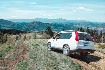 Poster - car travel concept suv driving by country road leading to the mountains