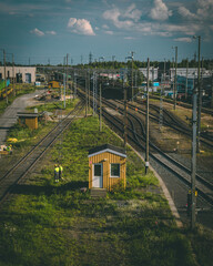 Sticker - Vertical view of railway station surrounded by grass