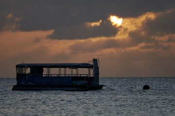 Scenic view of the sunset over the sea and an old river tram