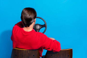 Poster - Behind view photo of confident male driving automobile traveling on holidays isolated on blue color background