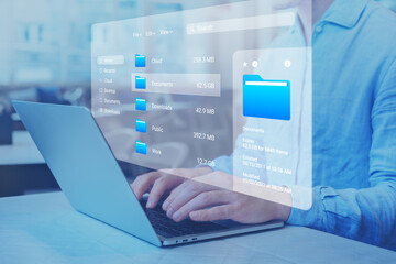 Document management system (DMS) and file manager used to browse folders on computer. Exploring directories on hard drive. Business data and process. Person working on laptop.