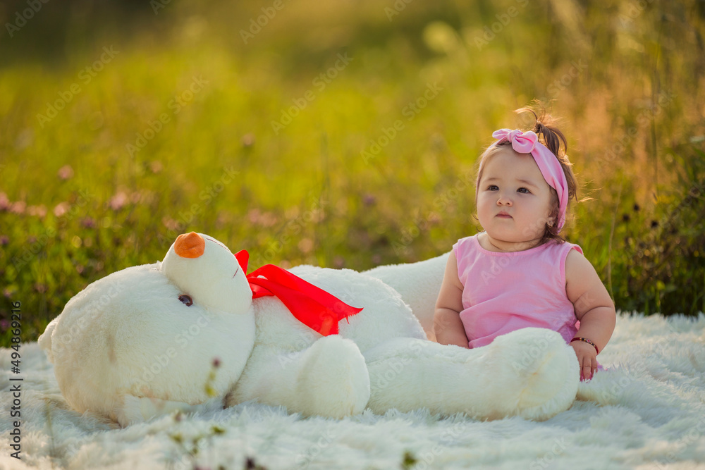 little girl with a big teddy bear in nature Stock Photo | Adobe Stock