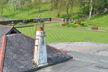 Television Aerials On Old Rooftop Chimney Stack  With Distant Bowling Green