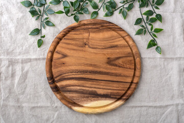 Wall Mural - Wood plate, board for pizza on linen tablecloth background