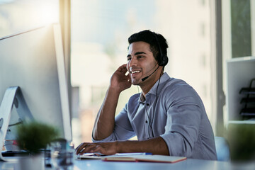 Canvas Print - He knows just how to solve your problem. Cropped shot of a call centre agent working in an office.