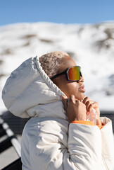 Sticker - Vertical shot of an African American woman wearing winter glasses and a jacket.