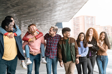 Young multiracial friends having fun together hanging out in the city - Friendship and diversity concept