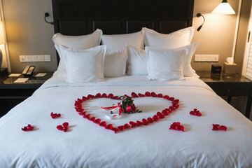 Honeymoon, Wedding bed topped with rose petals swain on a special day marry surprise on the big day