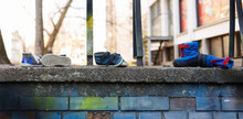 Various Kids Shoes On A Concrete-civilian Casualties Concept