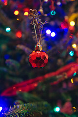 Poster - Vertical shot of a red ball as a Christmas decoration