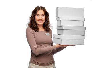 Poster - sale, shopping and business concept - happy female shop assistant or saleswoman holding four shoe boxes white background