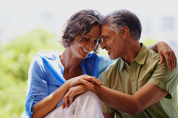 Canvas Print - Like love-struck teenagers. A cropped shot of an affectionate mid adult couple sitting outdoors.