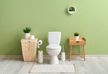 Interior Of Stylish Restroom With Toilet Bowl And Paper Rolls