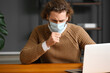 © Pixel-Shot - Ill man wearing medical mask in office