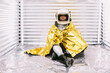 © ADDICTIVE STOCK - Black astronaut wrapped in emergence blanket