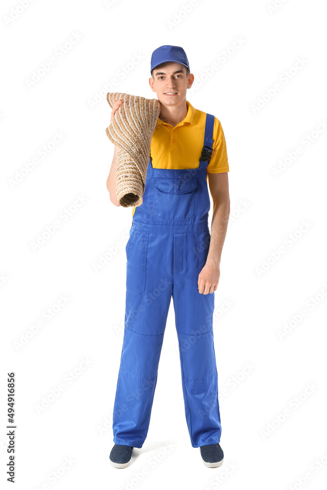 Male worker with rolled carpet on white background