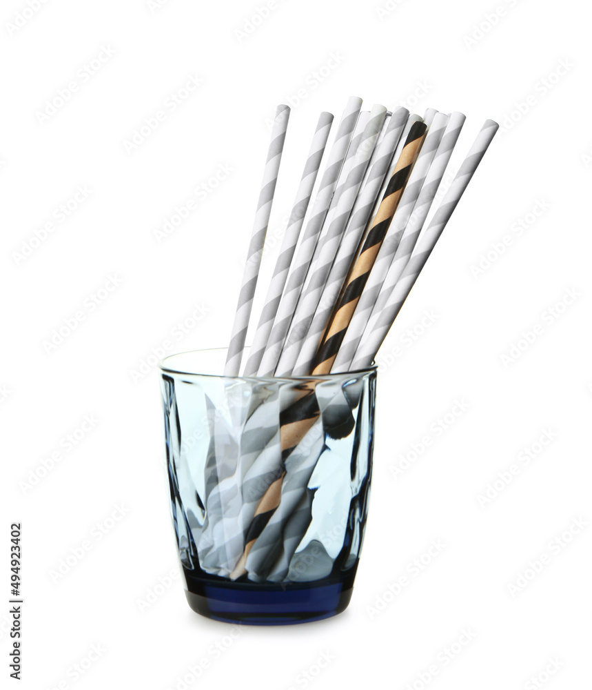Glass with stylish straws for drinks on white background. Concept of uniqueness