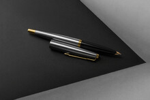 Luxurious Fountain Pen With The Lid Next To It On A Black And Gray Background