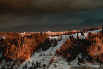 Poster - photo of a winter landscape at sunset over an isolated village in bucegi mountains in romania