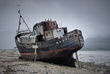 Place Of A Shipwreck, The Abandoned Former Fishing Trawler Boat On The Shore. Scotland.