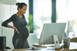 Tying together some loose ends before maternity leave. Shot of a pregnant businesswoman working in an office.