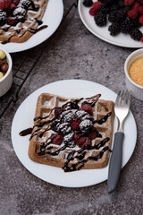 Poster - Photo of chocolate waffle with raspberries, a bowl of chocolate, and raspberries plate