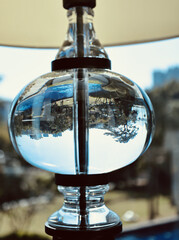 Sticker - Vertical shot of a glass pot full of water with a reflection of a backyard