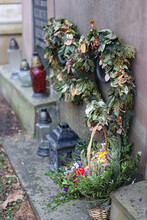 Wreaths Of Dry Flowers On The Grave In The Cemetery.