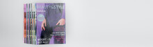 Stack Of Beauty And Style Magazines Isolated On Grey, Top View, Banner.