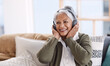 © Tinashe N/peopleimages.com - Some tunes will stay my favourite forever. Shot of a senior woman wearing headphones while listening to music at home.
