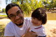 © Antonio Tanaka - portrait of a Hispanic father and baby in a park smiling and having fun