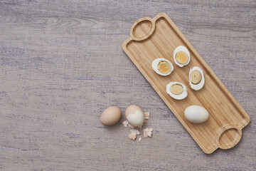 Sticker - Top view shot of boiled eggs on a wooden board in a kitchen