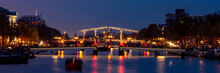 Panoramic View Of Magere Brug (English: Skinny Bridge) At Night, Amsterdam, The Netherlands.