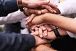 © Nikish H/peopleimages.com - We work better when we get together as one. Closeup shot of an unrecognizable group of businesspeople joining their hands in a huddle.