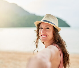 Wall Mural - The beach is calling. Portrait of a young woman on holiday leading her unidentifiable boyfriend by the hand.