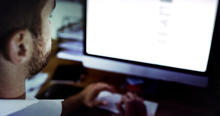 Sticker - Putting in the work. High angle shot of a handsome young businessman working late in the office.