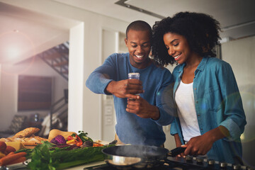 Fototapete - Some pepper goes a long way. Shot of a cheerful young couple taking a photo of the ingredients of the meal they are about to prepare together at home.