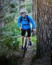 Hes One Determined Mountain Biker. Shot Of A Male Cyclist Riding Along A Mountain Bike Trail.