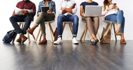 Poster - Going online in different ways. Cropped shot of a group of unrecognizable businesspeople waiting in line for an interview.