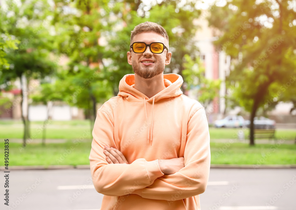 Young guy in stylish hoodie outdoors