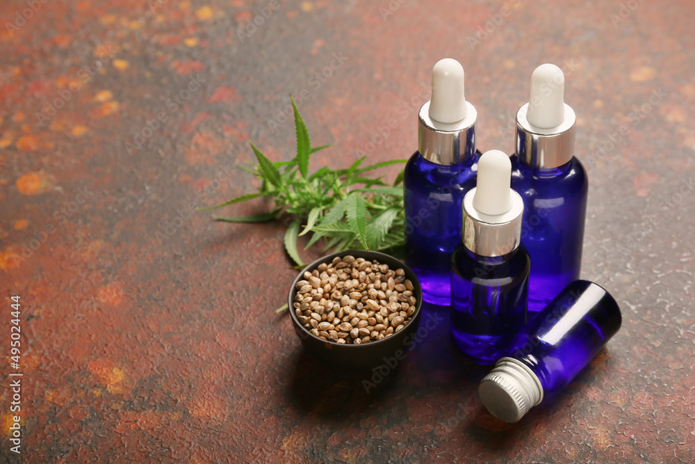 Bottles of CBD oil on color background