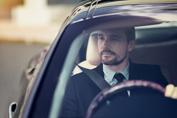 Canvas Print - His car says a lot about him. Cropped shot of a businessman on his morning commute to work.