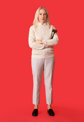 Poster - Mature female judge with gavel on red background