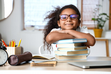 Sticker - Little African-American girl with books studying at home