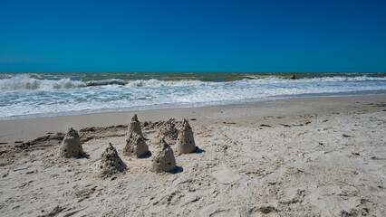Fototapete - Sand Castles and Waves On Beach Naples Florida