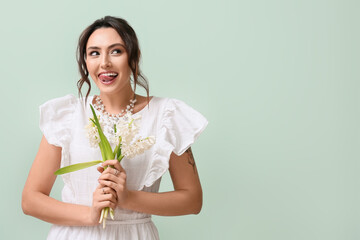 Sticker - Pretty young woman with hyacinth flowers on green background