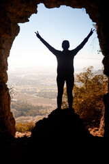 feeling on top of the world. silhouette of a mature woman hiking in nature.
