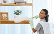 © Cara C C/peopleimages.com - Chore day is the best day. Shot of a young woman cleaning a surface at home.