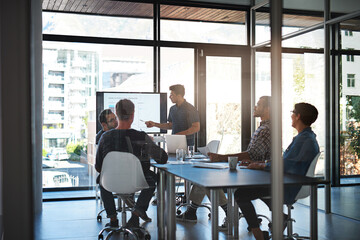 Sticker - His presentations are always precise and concise. Shot of a young businessman giving a presentation in the boardroom.