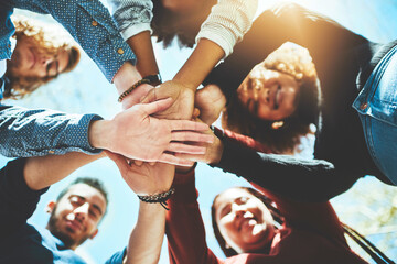 Wall Mural - Do it together and do it right. High angle portrait of a diverse group of college friends standing outside with their hands in a huddle.
